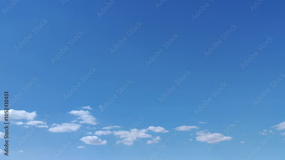 Small white clouds moving below Small white clouds moving below