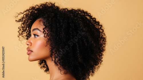 close-up, portrait of a young beautiful girl model with curly hair on a beige background, copy space
