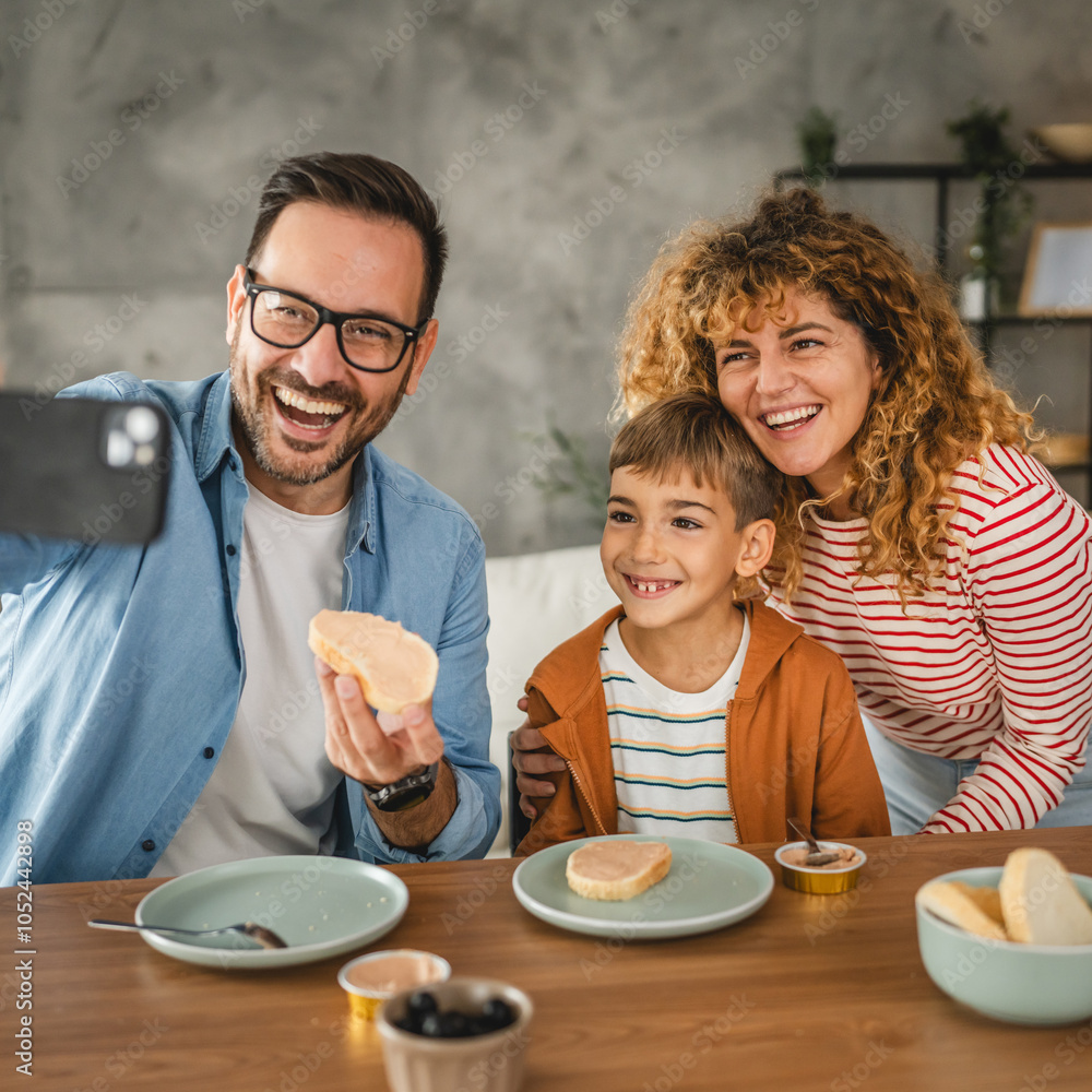 family of three take a self portrait while have breakfast family of three take a self portrait while have breakfast