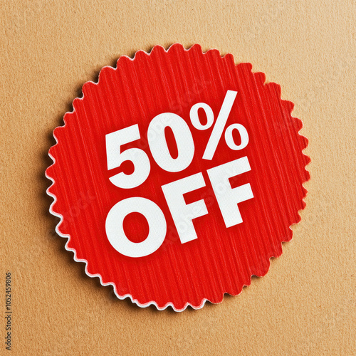 Bright red 50% off sticker on brown cardboard background promoting discounts and sales photo