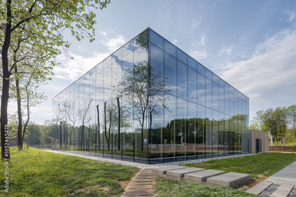 Glass Cube Building Reflecting Nature in Tranquil Forest Setting Glass Cube Building Reflecting Nature in Tranquil Forest Setting