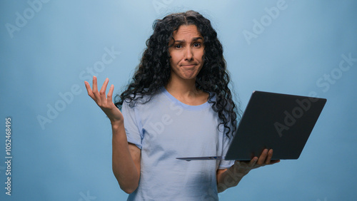 Shocked frustrated Indian student girl Latino upset woman businesswoman with computer failure stressed shock with laptop bad news business online problem failed exam results at studio blue background