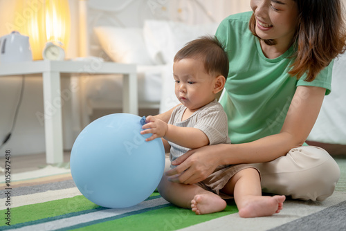 Asian baby and woman doing lifestyle activities together at home.