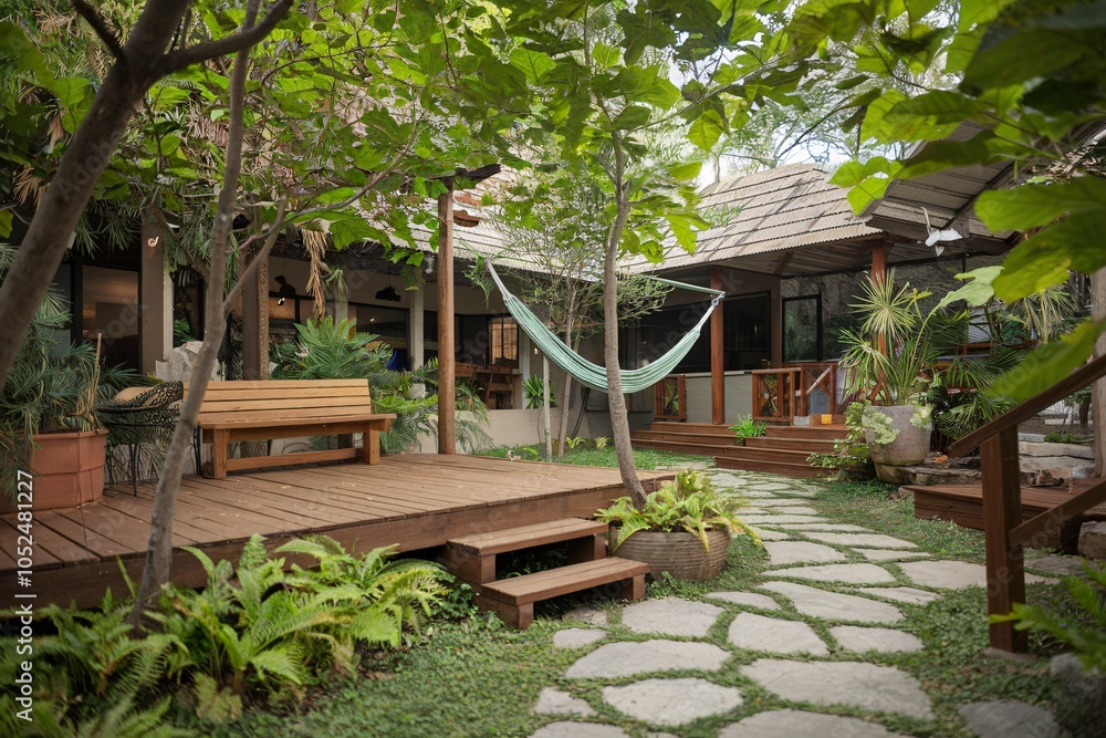 Tranquil Garden with Wooden Deck, Hammock, and Lush Greenery Tranquil Garden with Wooden Deck, Hammock, and Lush Greenery