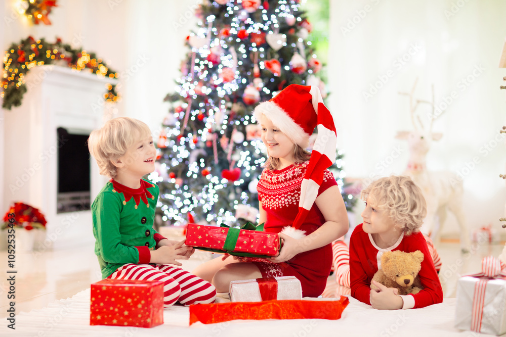 Child at Christmas tree. Kids at fireplace on Xmas Child at Christmas tree. Kids at fireplace on Xmas