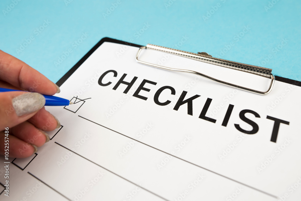 A blank checklist during a security audit and risk review. security checklist form. a hand with a pen writes a tick on a checklist. A blank checklist during a security audit and risk review. security checklist form. a hand with a pen writes a tick on a checklist.