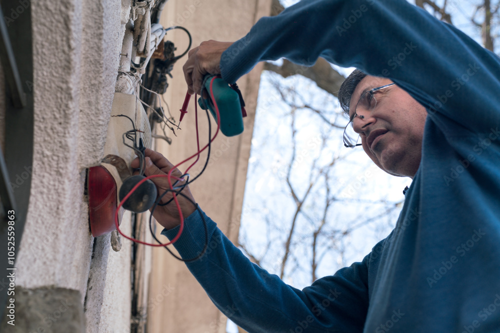 Electrical technician measuring the energy efficiency of a house. Electrical technician measuring the energy efficiency of a house.