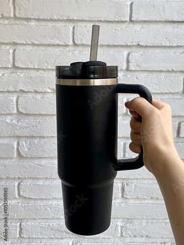 Hand Holding Black Insulated Tumbler with Straw – Reusable, Eco-friendly, and Portable Beverage Container for Everyday Hydration
