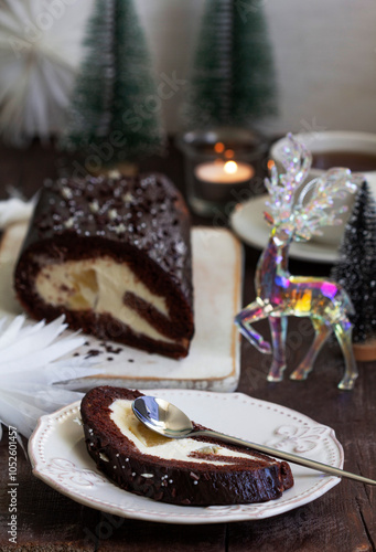 Obraz na płótnie Chocolate roll stuffed with butter cream and pineapple on a Christmas background. Rustic style. w salonie