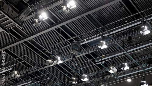 A large studio ceiling rig with exposed structure and many hanging spotlights