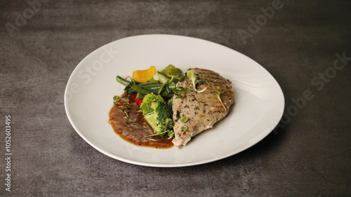 Chicken Breast with veggies in white ceramic plate photo