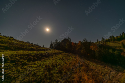 Autumn meadows with full moon near cottage in Biala Woda Poland photo