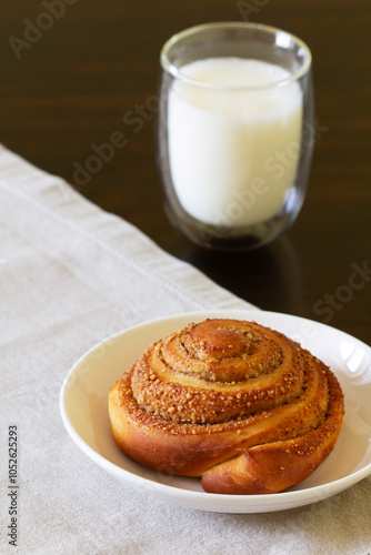 Cinnamon buns with icing served with coffee. Rustic style.