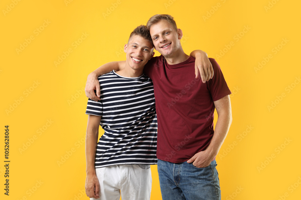 Portrait of happy brothers on orange background