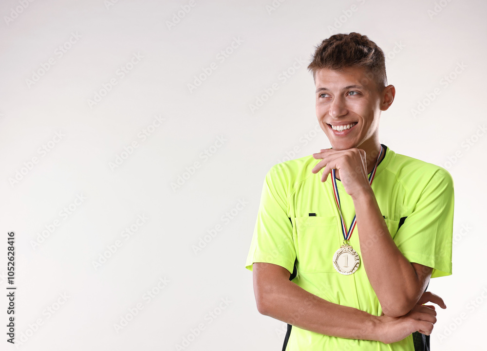 Happy winner with golden medal on light grey background. Space for text Happy winner with golden medal on light grey background. Space for text