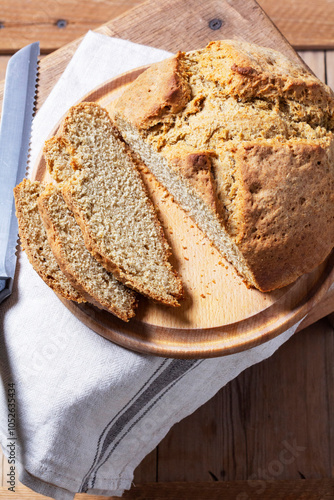 Obraz na płótnie Homemade Irish soda bread cut into pieces and knife on wooden background. w salonie