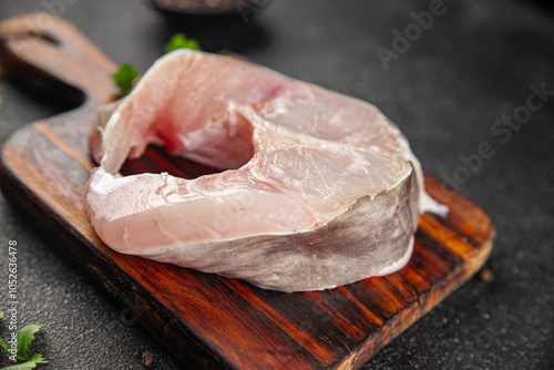 Eel steak European conger raw fish piece portion tasty food dish Fresh gourmet food background on the table  pescetarian diet vegetarian rustic food copy space top view photo