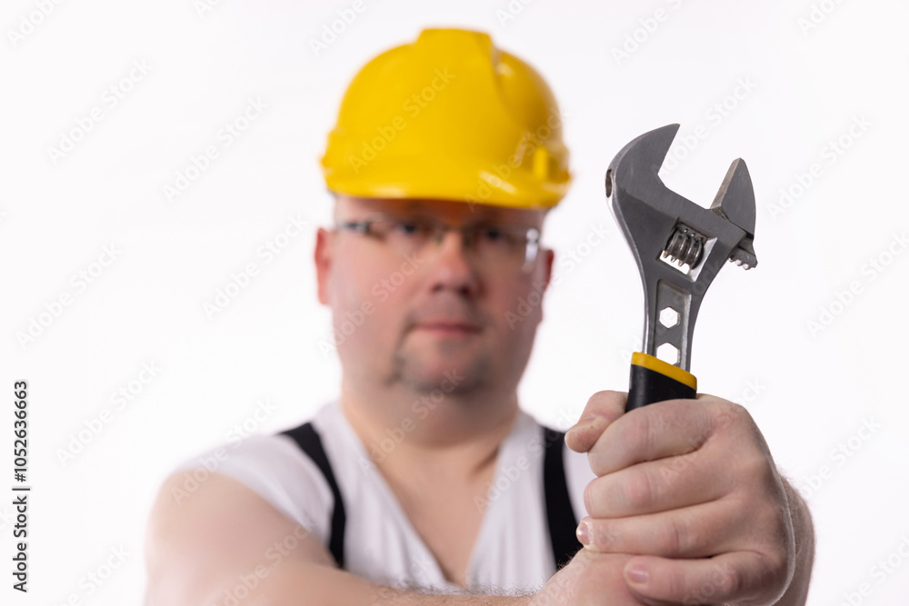 A Construction Worker Holding an Adjustable Wrench, Showcasing Skills and Dedication A Construction Worker Holding an Adjustable Wrench, Showcasing Skills and Dedication