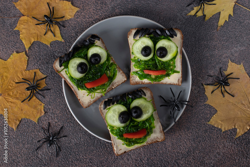 Green monster sandwiches for Halloween with chuka seaweed and black olives photo