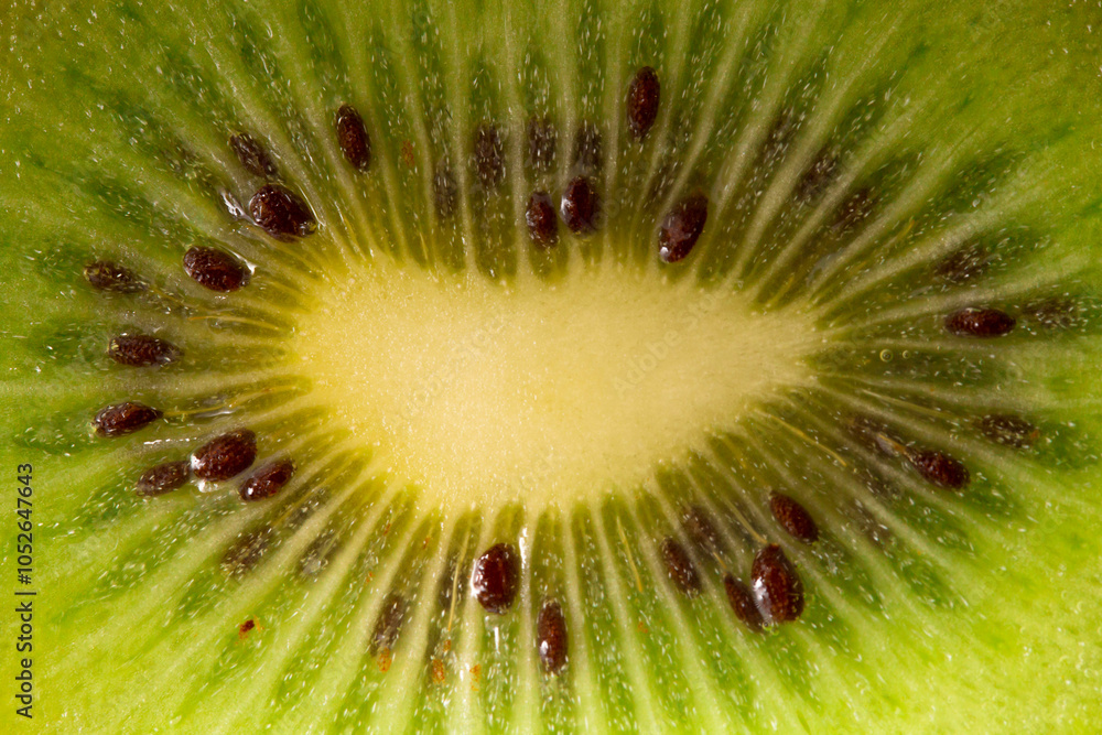 A kiwi fruit with pits taken in close-up on a white background. the texture of the kiwi fruit A kiwi fruit with pits taken in close-up on a white background. the texture of the kiwi fruit