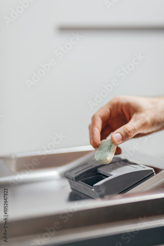 Obraz na płótnie Man putting detergent tablet into open dishwasher indoors, closeup w salonie