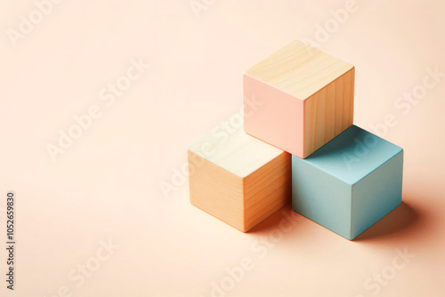 Pastel wooden cubes on a light background. Space for text. photo