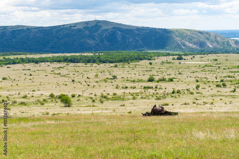 Old destroyed Russian tank on a grassy field Old destroyed Russian tank on a grassy field