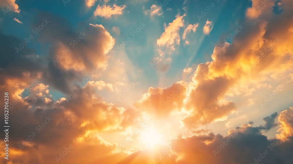 A beautiful sunset sky with dramatic clouds featuring orange and blue colors Sun rays are shining through the clouds creating a captivating concept with ample A beautiful sunset sky with dramatic clouds featuring orange and blue colors Sun rays are shining through the clouds creating a captivating concept with ample