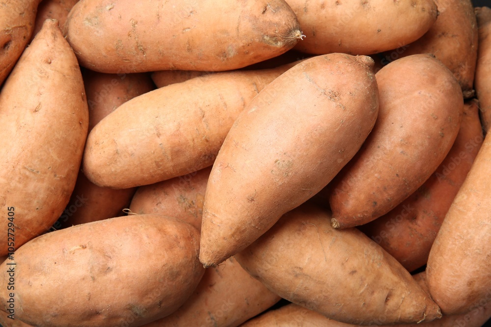 Fresh raw sweet potatoes as background, top view Fresh raw sweet potatoes as background, top view