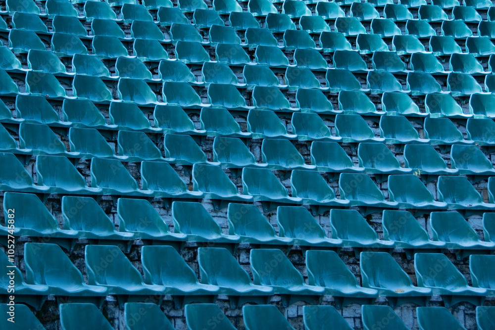 Fototapeta premium Blue seats of tribune on sport stadium empty outdoor arena concept of fans chairs for audience cultural environment concept color empty seats modern stadium.