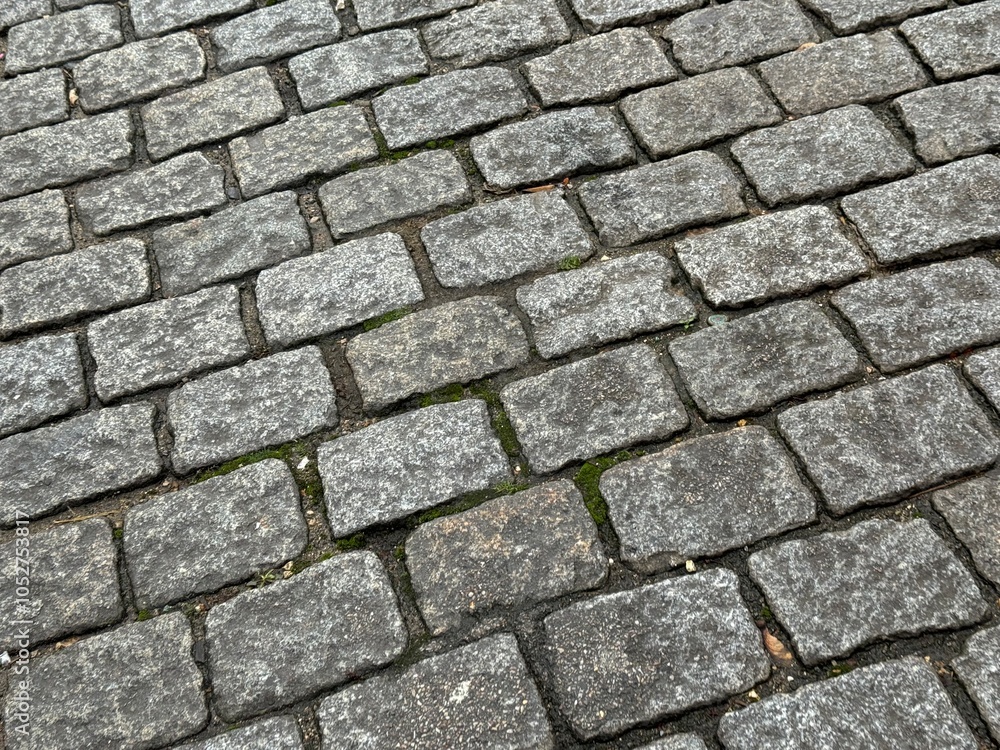Full frame background of damp drying grey cobblestones Full frame background of damp drying grey cobblestones