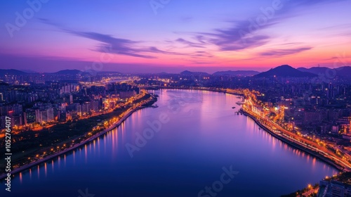 An aerial view of the Han River in Seoul, featuring sparkling city lights and reflections