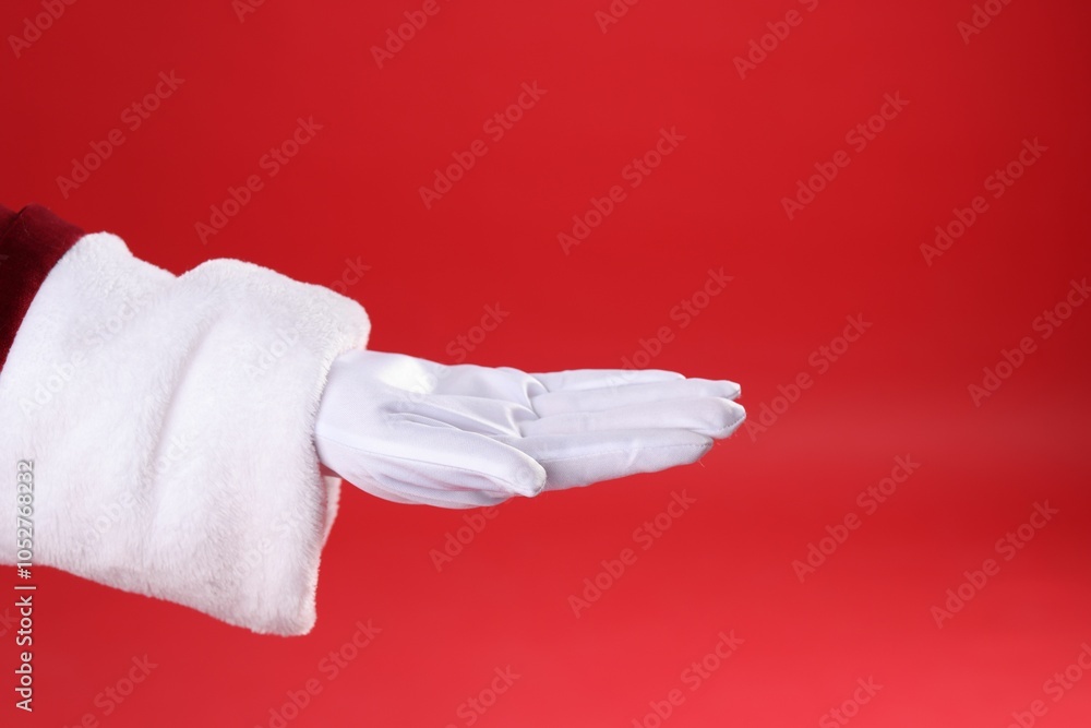 Santa Claus holding something on red background, closeup Santa Claus holding something on red background, closeup