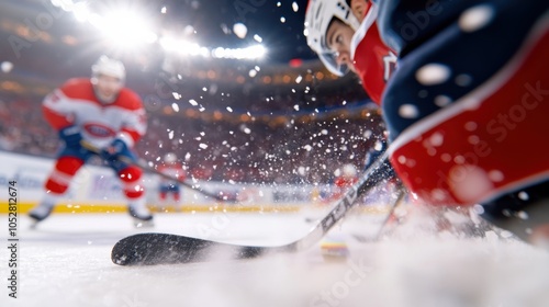 An up-close view of an intense hockey game featuring players in action, blurred in motion, with ice chips flying around as they fiercely compete on the rink. photo