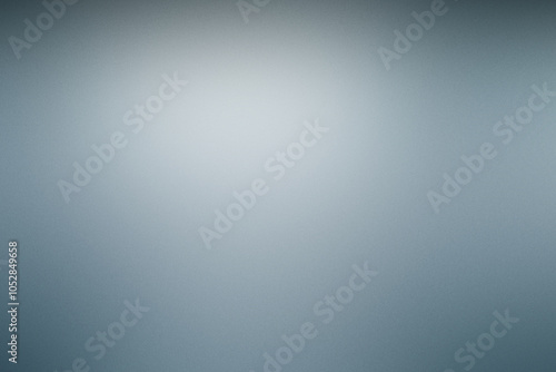 A blurry gray background with a white light shining on it. Noisy background with grain