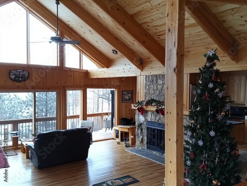 Cozy Christmas tree by the fireplace in a small American home warm and inviting photo