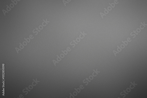 A grey background with no visible objects. Noisy backdrop with grain