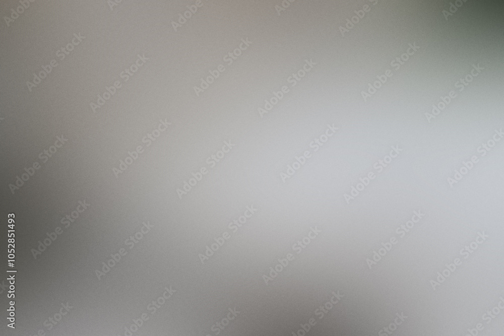 A blurry gray background with a white object in the foreground. Noisy backdrop with grain A blurry gray background with a white object in the foreground. Noisy backdrop with grain