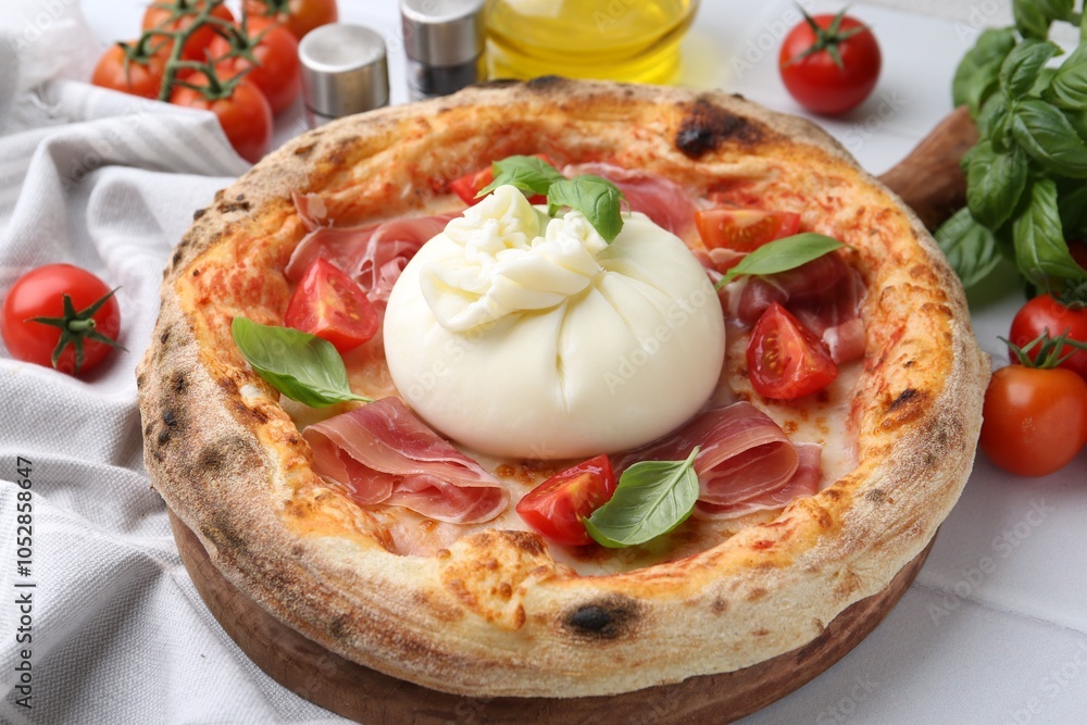 Delicious pizza with burrata cheese, basil, tomatoes and ham on white table, closeup Delicious pizza with burrata cheese, basil, tomatoes and ham on white table, closeup
