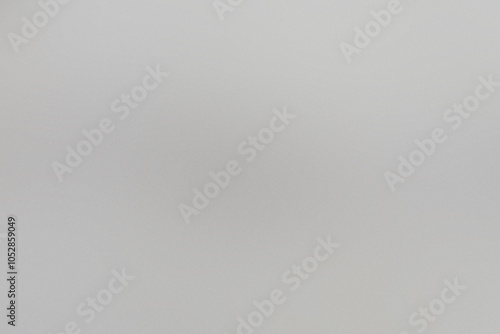 A white background with a blurry grayish-white line. Noisy backdrop with grain