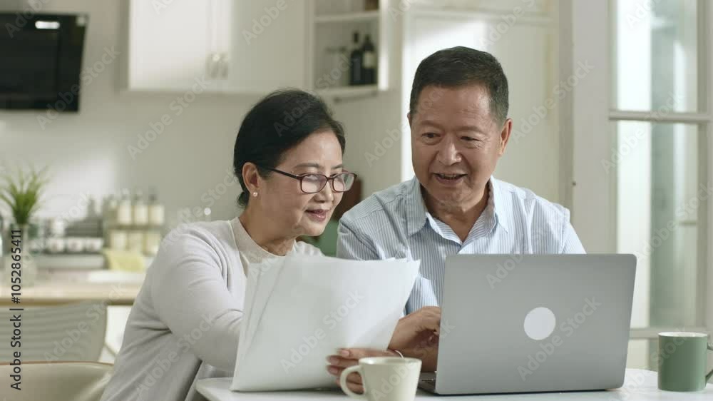 senior asian couple making family financial plan using laptop computer at home senior asian couple making family financial plan using laptop computer at home