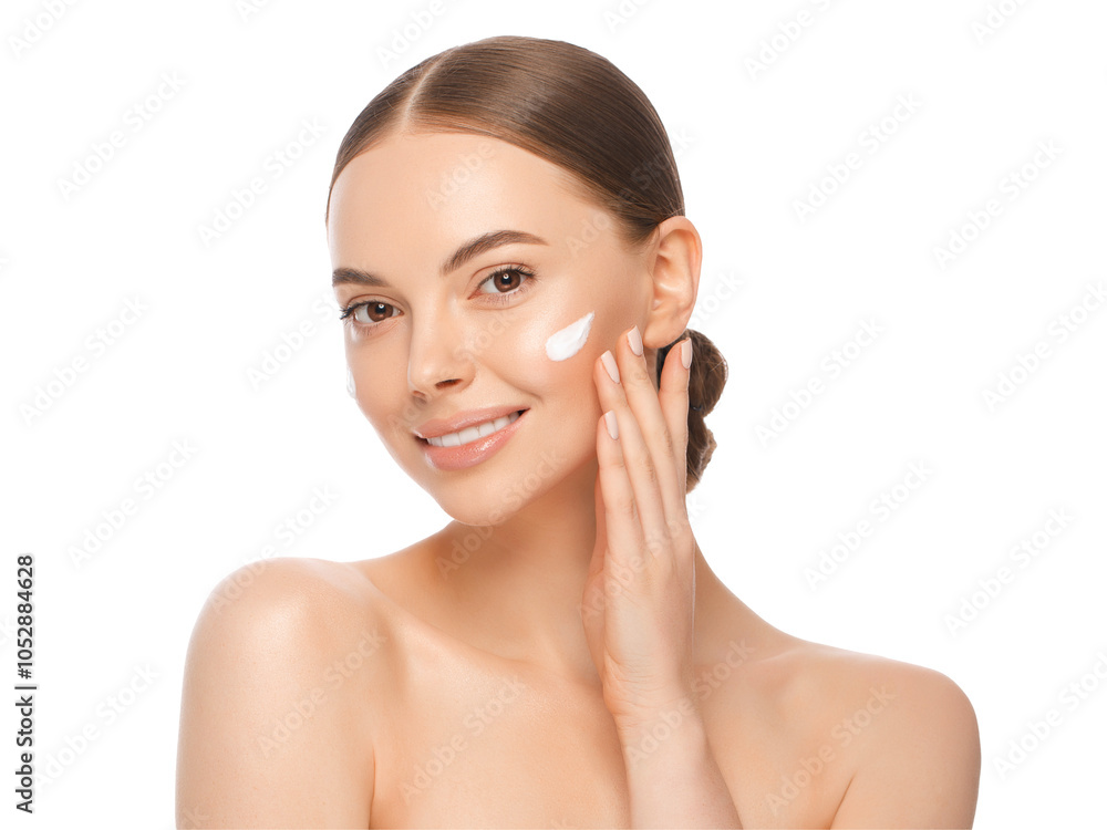 Close-up portrait of young beautiful woman with face cream applied on cheekbones and glowing skin Close-up portrait of young beautiful woman with face cream applied on cheekbones and glowing skin