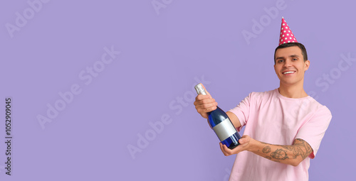 Young man in party hat with...