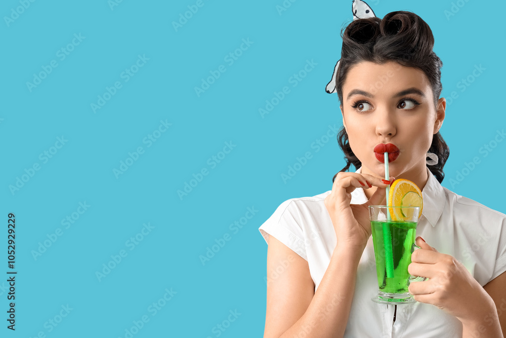 Attractive pin-up woman drinking cocktail on blue background, closeup Attractive pin-up woman drinking cocktail on blue background, closeup