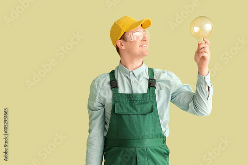 Male electrician with light...