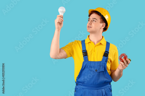 Male electrician with light...