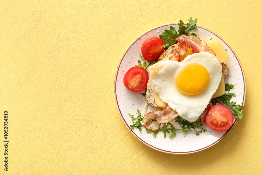 Plate with tasty fried egg, toast, bacon, tomatoes and arugula on beige background Plate with tasty fried egg, toast, bacon, tomatoes and arugula on beige background