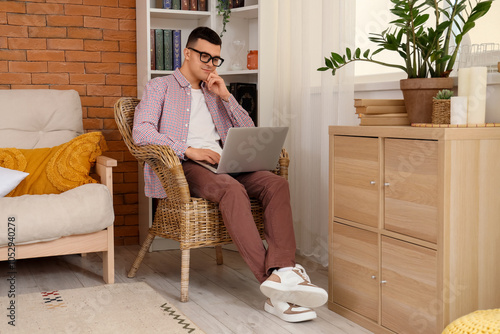 Male author using laptop in...