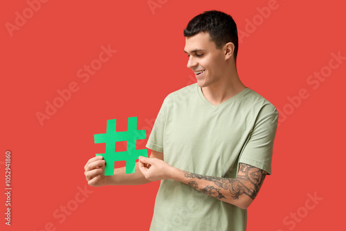 Young man holding green has...