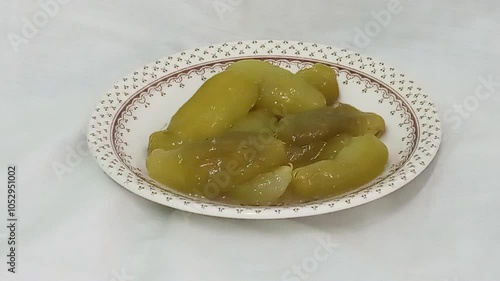 bilimbi fruits halwa  in a plate up on white  background. Halva also known as halvah, halwa is a type of confectionery or candy.cucumber  tree, tree sorrel, bilimbi fruit.photo taken in malaysia photo